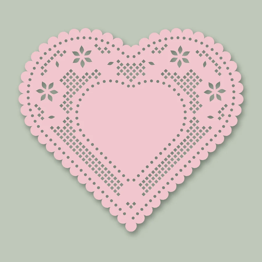 A pink heart-shaped paper lace doily with a scalloped edge and a solid heart in the middle
