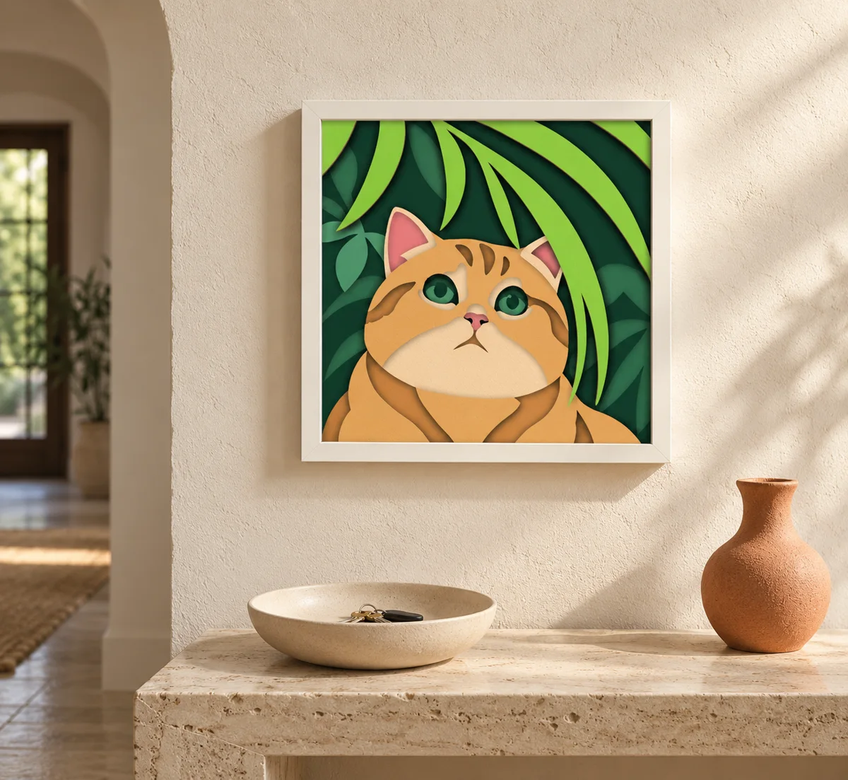 The color block cat and leaves cut as a layered papercut in a white frame on a wall