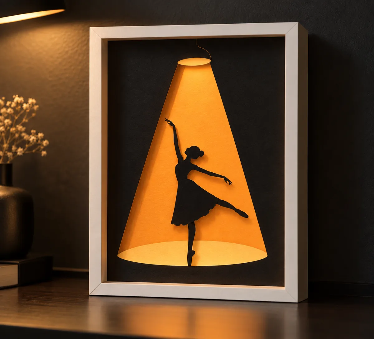 Ballerina silhouette layered papercut displayed in a room