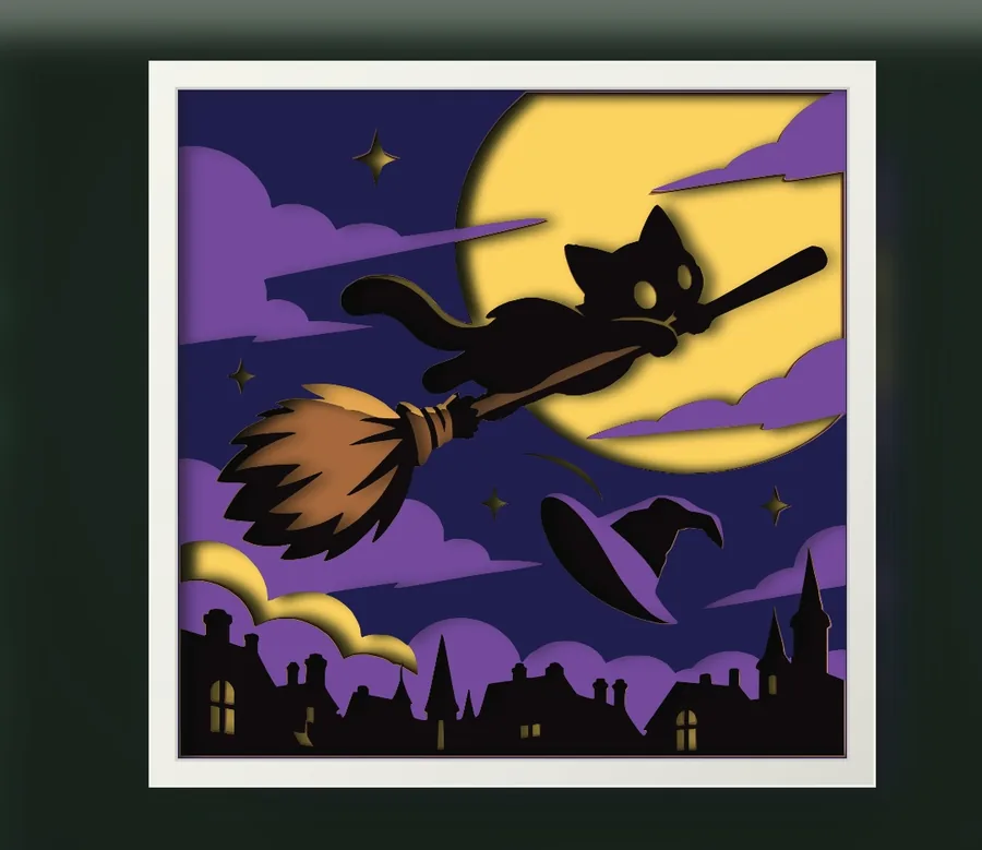 Finished black cat on a witch's broom layered papercut in a frame